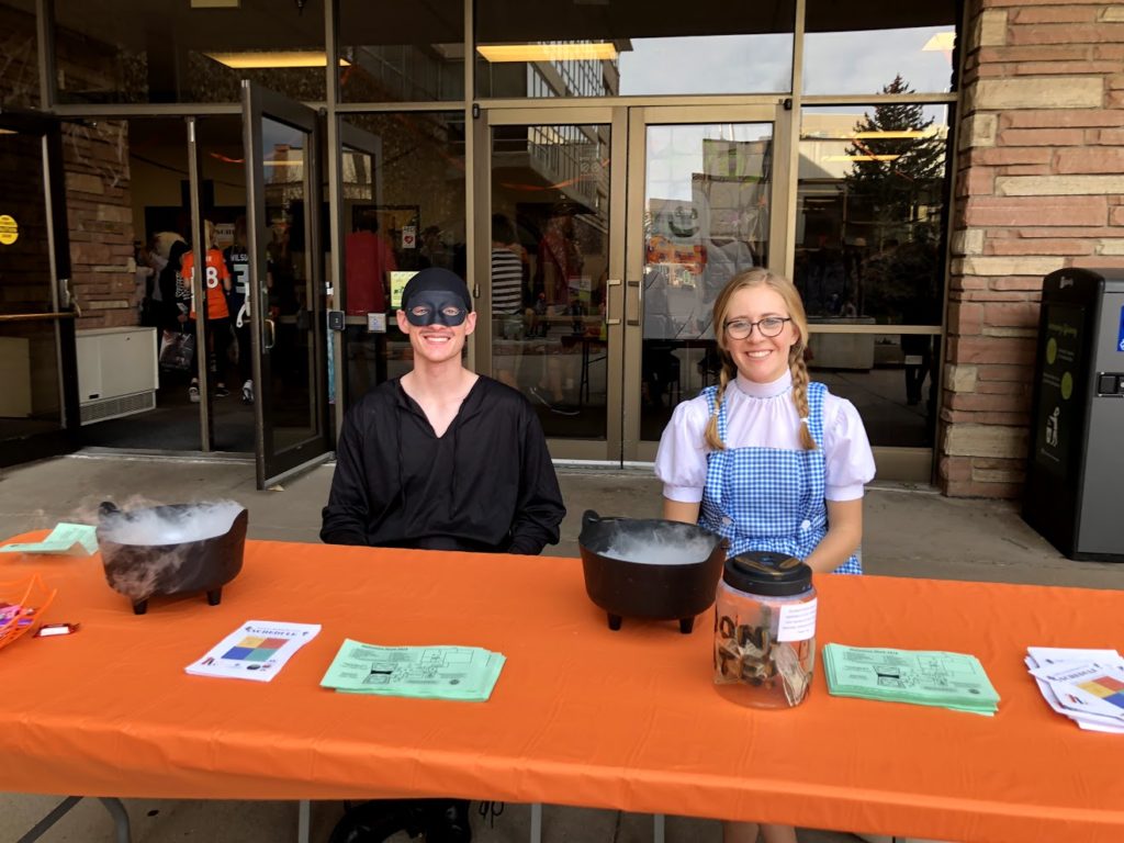 Image of chem club members greeting visitors at Halloween show