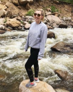 Marley webber standing on a rock in a river