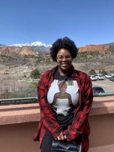 Ariana Mims smiling in front of a natural backdrop