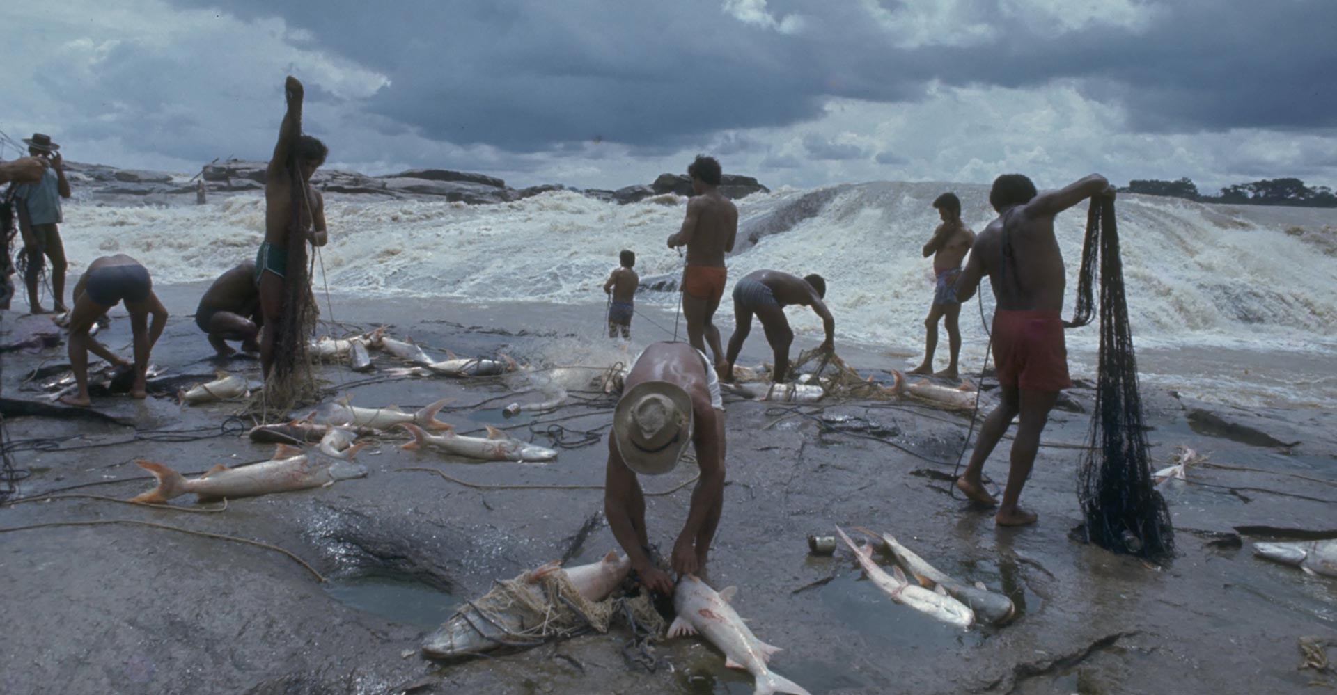 indigenous fishermen at a river rapids in the Amazon