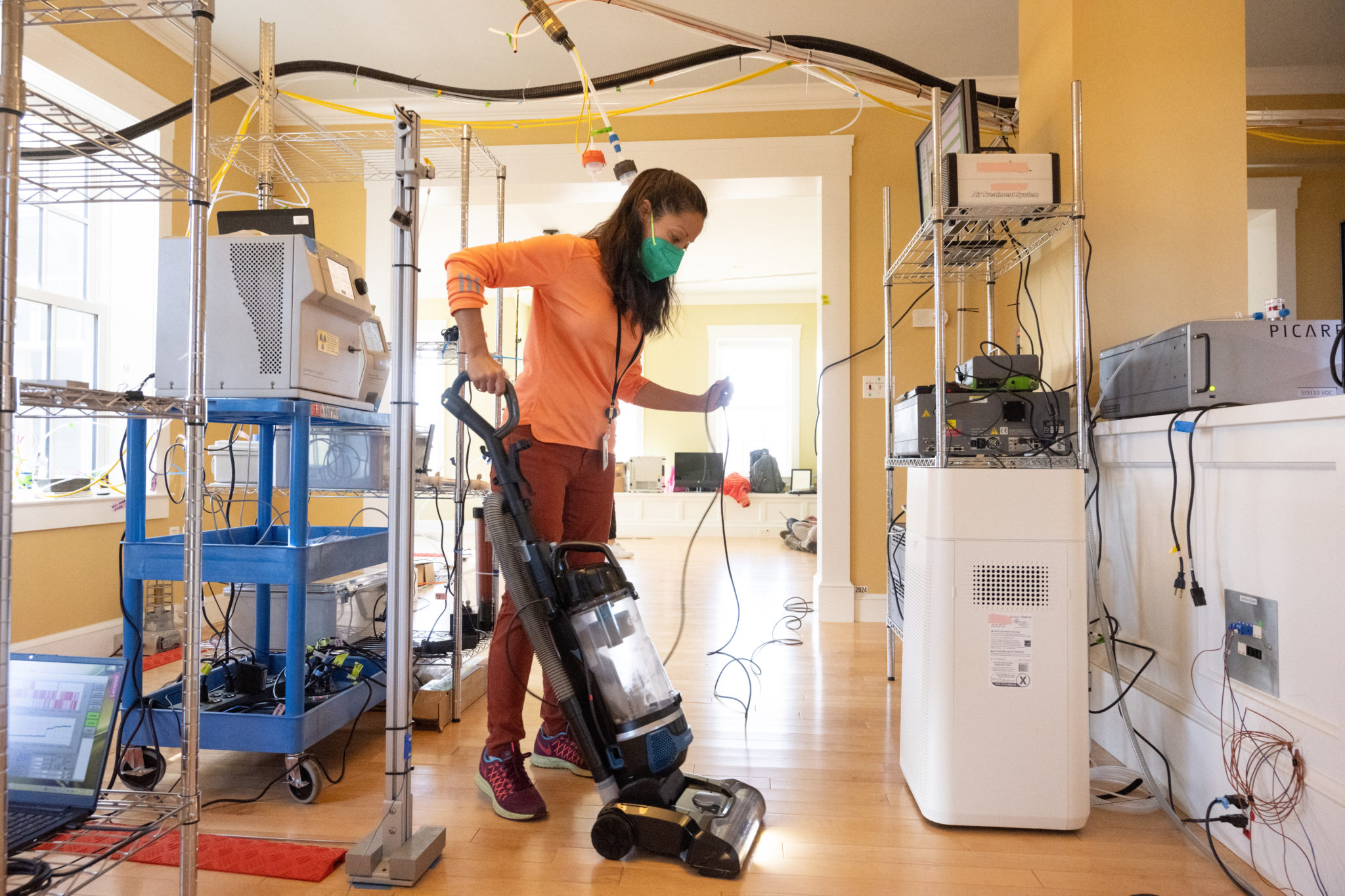 Researcher vacuuming inside Net zero house at NIST