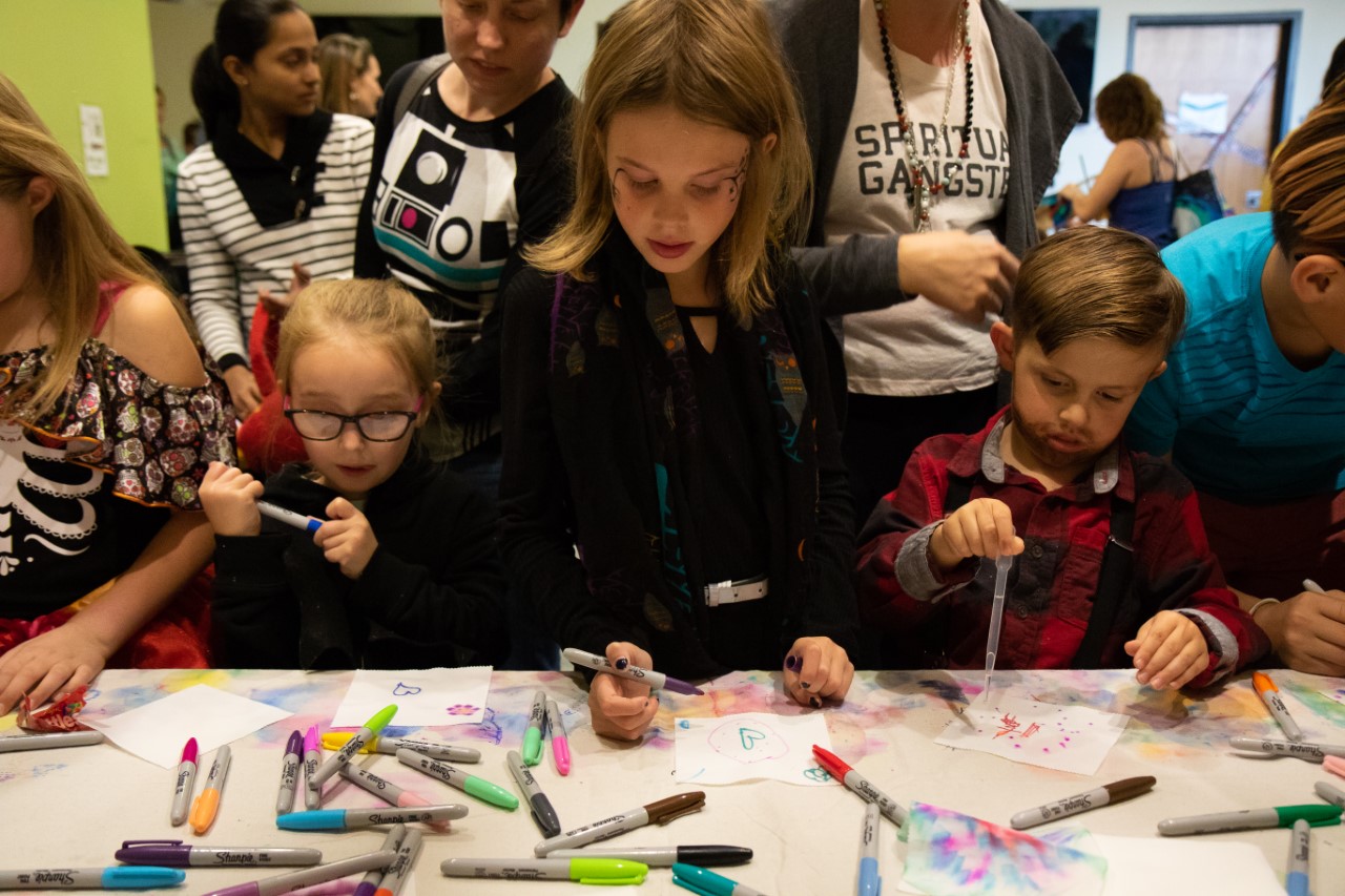 Kids enjoy a coloring table at the Halloween Show