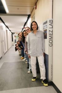 Andrea Gomez with students from her lab behind her.