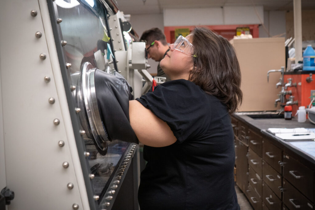 Kelly Nieto, who recently received her Ph.D from CSU, manipulates materials inside Amy Prieto's lab.